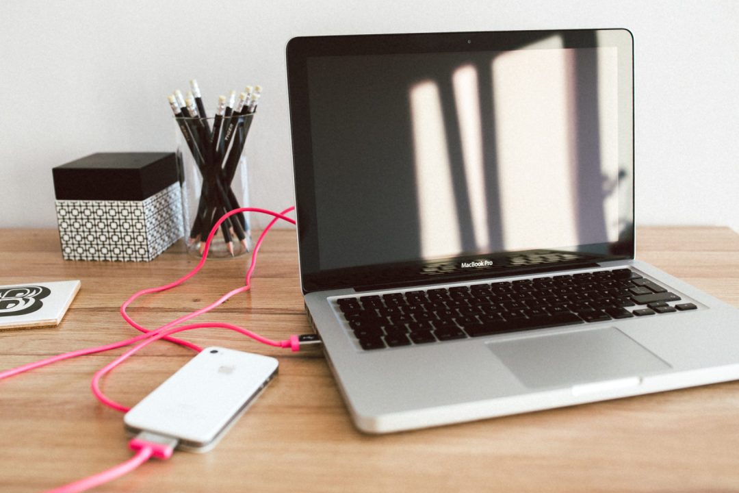 Apple Macbook Pro and iPhone 4s on the wooden desk